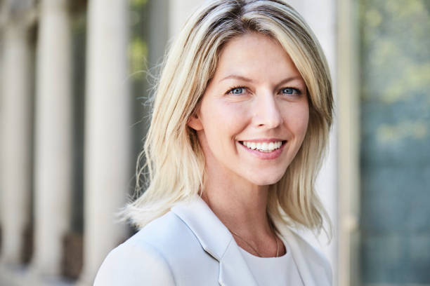 Smiling blond businesswoman looking at camera